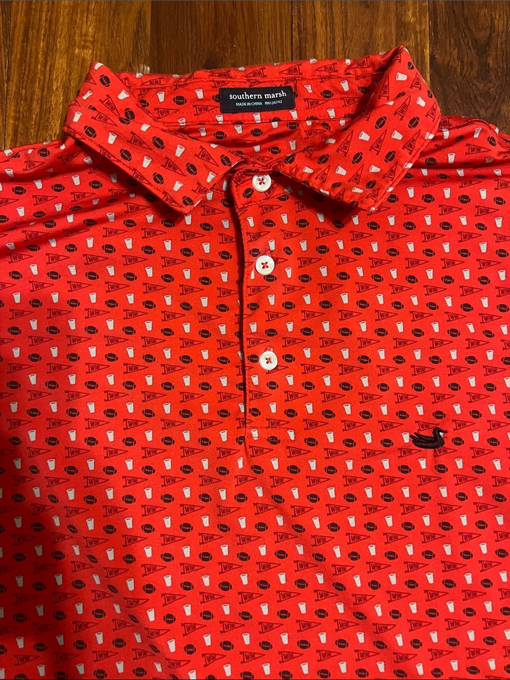 Southern Marsh Red Polo with game day football, pennant and cups